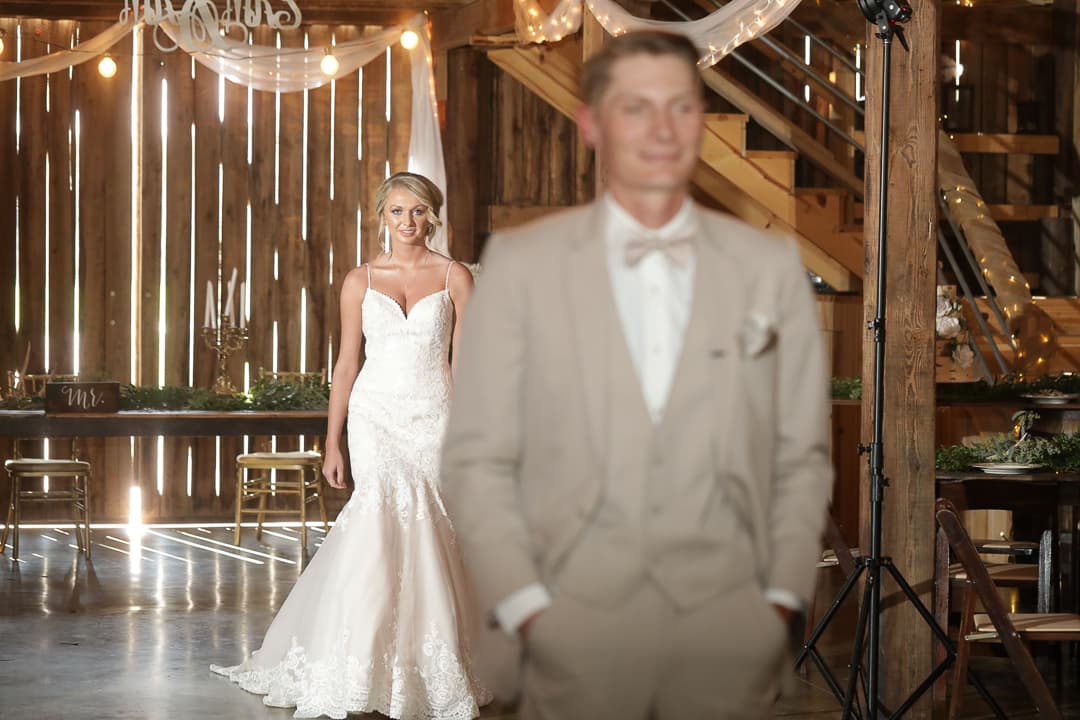 A bride walking into her candlelit reception